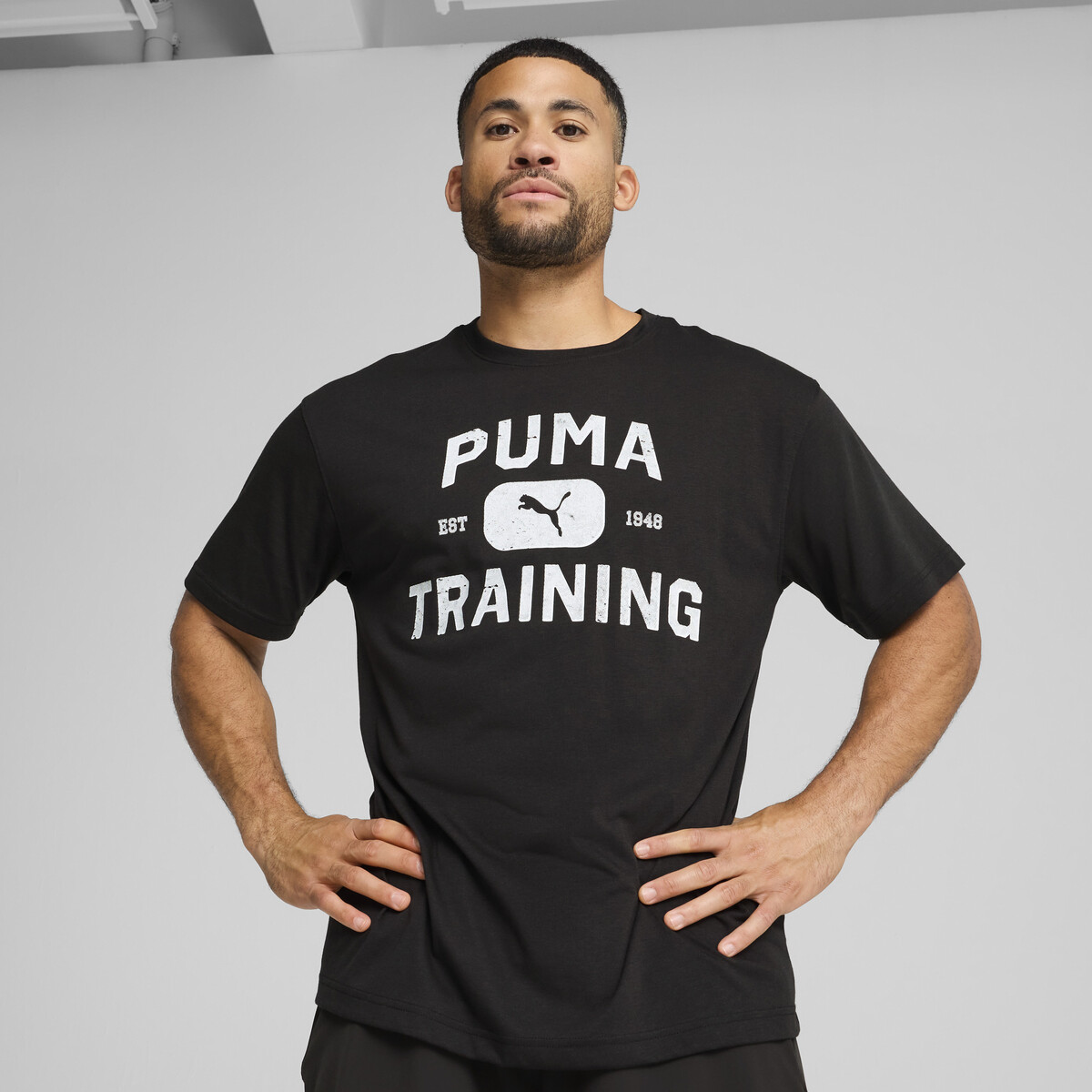 GRAPHICS Logo Relaxed Training T-Shirt Men in Black by PUMA, Small