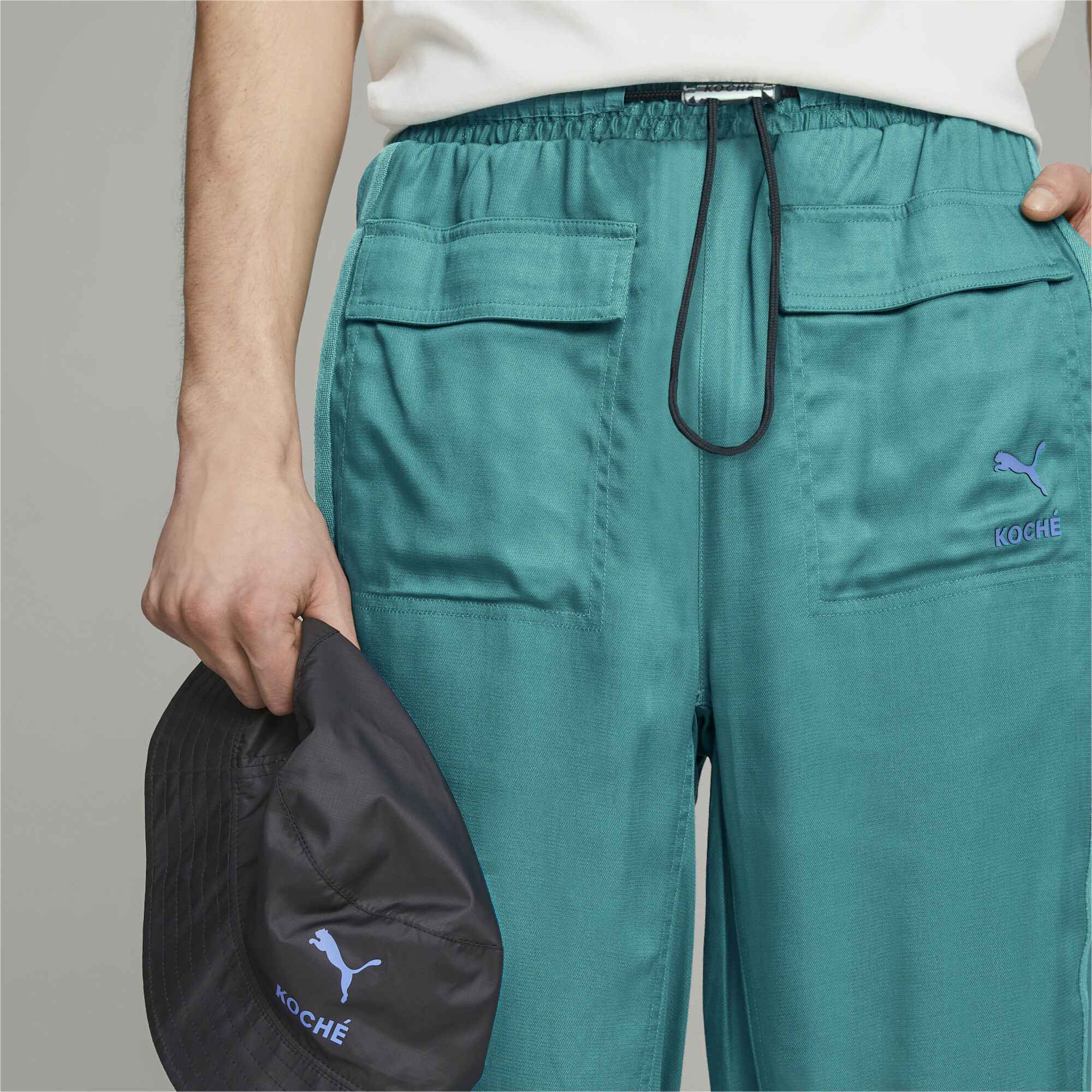 Men's PUMA X KOCHÃ Reversible Pants In Green, Size Large